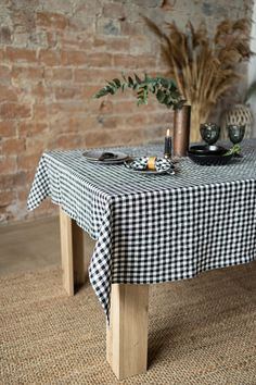 a black and white checkered table cloth on a wooden bench