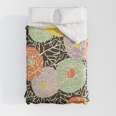 an image of a bed that is made up with flowers on the comforter and pillows