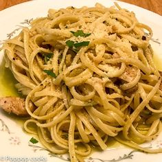 a white plate topped with pasta covered in sauce