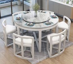 a white table with four chairs around it