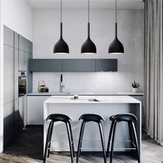 three black and white stools sit in front of an island with two bar stools