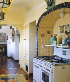 a kitchen with an oven, stove and dining room table