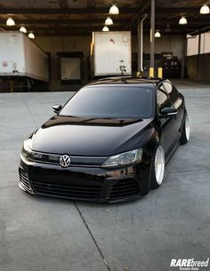 a black car parked in a parking garage