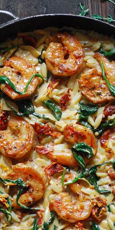 pasta with shrimp and spinach in a skillet