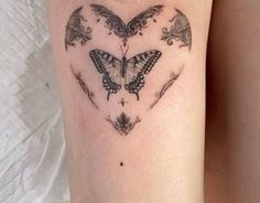 a woman's thigh with a butterfly tattoo on it