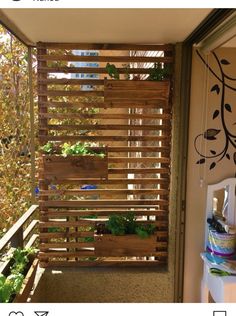 an open door leading to a balcony with wooden slats on the wall and plants growing inside