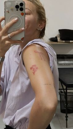 a woman taking a selfie with her cell phone in front of her ear and arm