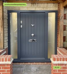 the front door to a house with brick pillars