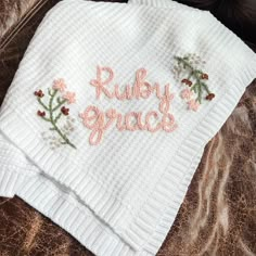 a close up of a towel on top of a bed with the words ruby grace written on it