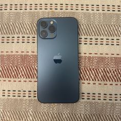 an iphone 11 pro sitting on top of a blanket