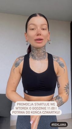 a woman with tattoos on her chest and arms