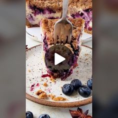 a blueberry crumb pie with a fork stuck in it