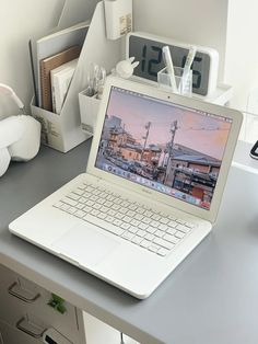 an open laptop computer sitting on top of a desk