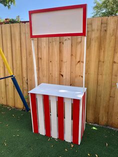 a wooden bench made to look like a circus tent with red, white and blue stripes