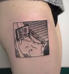 a woman with a book tattoo on her thigh is looking at the viewer's image