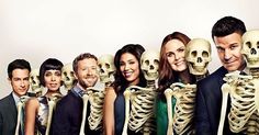 a group of people standing next to each other with skeleton heads