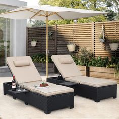 two chaise lounge chairs with an umbrella over them