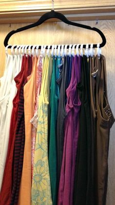 an assortment of clothing hanging on a rack