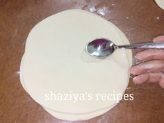 a person is using a spoon to make dough