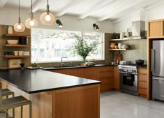 a kitchen with wooden cabinets and stainless steel appliances