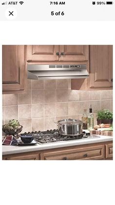 a stove top oven sitting inside of a kitchen next to wooden cabinets and counter tops