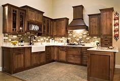 a kitchen with wooden cabinets and white counter tops