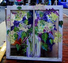 an old window with flowers painted on it