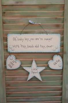 a wooden sign hanging from the side of a door with words written on it and two stars