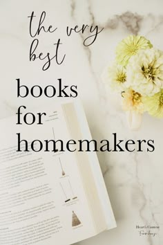 the very best books for homemakers on a marble countertop with flowers and an open book