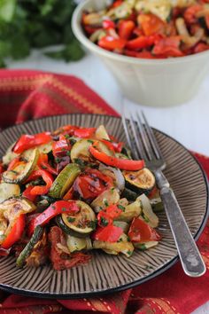 a plate full of vegetables with a fork on the side