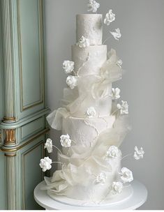 a wedding cake with white flowers on top