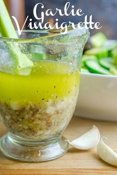 a bowl filled with food sitting on top of a table next to sliced cucumbers