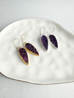 Purple Druzy Teardrop Earring Gold & Silver. Gemstone Drop Earrings. Gold Silver Crystal Earrings This rustic, yet elegant pair features glimmering druzy stones that will truly enchant those around you. GEMSTONE: Druzy CLOSURE: Gold/Silver plated kidney ear wires LENGTH: 1.25" long Questions?  Please don't hesitate to start a convo, we'd love to hear from you! WELCOME! Welcome to Rustic Gem Jewelry! Thank you for visiting our shop. We take custom orders and can often do a similar piece in different colors. We also offer bulk / bridal discounts. If you have any questions regarding this item, please let us know. We're more than happy to help. MATERIALS We use 14k gold filled chain or sterling silver chain, almost exclusively. We use high quality chain, stones and materials. While we try to t Purple Teardrop Earrings With Natural Stones, Purple Gemstone Teardrop Earrings, Purple Nickel-free Teardrop Dangle Earrings, Teardrop Multi-stone Amethyst Earrings, Teardrop Earrings Gold, Nickel-free Purple Teardrop Crystal Earrings, Silver Crystal Earrings, Gem Jewelry, Drop Earrings Gold