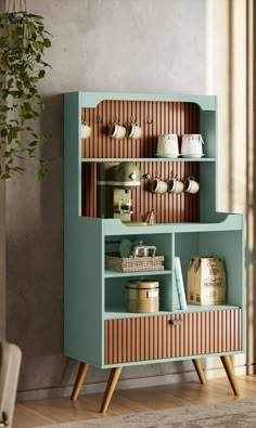 a blue cabinet with wooden shelves and drawers on it's sides, next to a potted plant