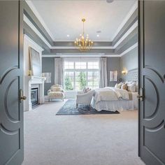 an open door leading to a bedroom with a chandelier