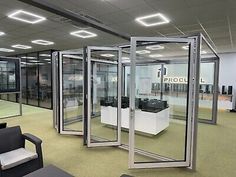 an office with glass walls and chairs in the middle is empty except for people to use it