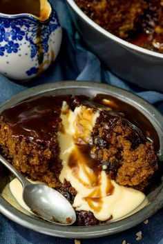 a close up of a plate of cake with ice cream and chocolate sauce on it