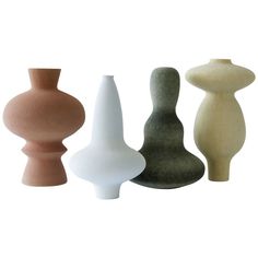 three different colored vases sitting next to each other