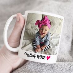 a person holding a coffee mug with a photo on it