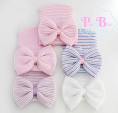 three different colored bow ties on top of white and pink striped ones with blue stripes