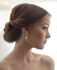 an image of a woman with long hair and earrings on her head, looking off to the side