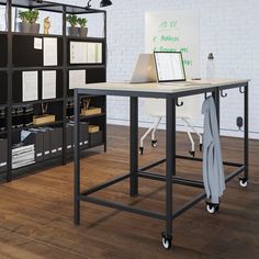 a desk with a white board on it next to some black boxes and shelves filled with books