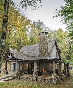 a log cabin with a stone chimney in the woods