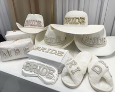 several hats and accessories are on display at a bridal event, including one for the bride