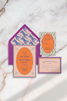 an orange and purple wedding suite on a marble background