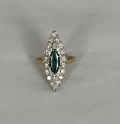 Marquise ring in yellow gold (18k) centered on a natural navette-cut emerald of approximately 1.00 ct in a surround of natural brilliant-cut diamonds. Total weight of diamonds: approximately 1.00 ct. Plate: 30 x 12 mm. Gross Weight: 8.90 g. Size: 55 Possibility of sizing, contact us. Further information : We issue an invoice as well as a certificate of authenticity established by our qualified gemologist (LFG Paris). Our photos are not reworked and are taken in a natural light environment. We ca Marquise Ring, Multi Stone Ring, Emerald Diamond, Multi Stone, Brilliant Cut Diamond, Yellow Gold Rings, Stone Rings, Natural Light, Emerald