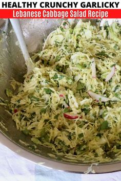 a bowl filled with shredded cabbage and radishes on top of a white table cloth