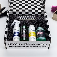 an open box containing three different types of hair care products on a white table with black and white checkered boxes