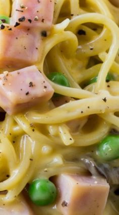 pasta with ham, peas and cheese on it