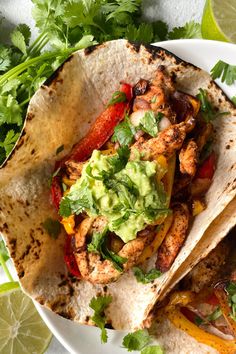 an air fryer chicken fajita on a plate with cilantro and avocado